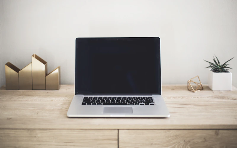 Laptop on a simple wooden desk in natural light